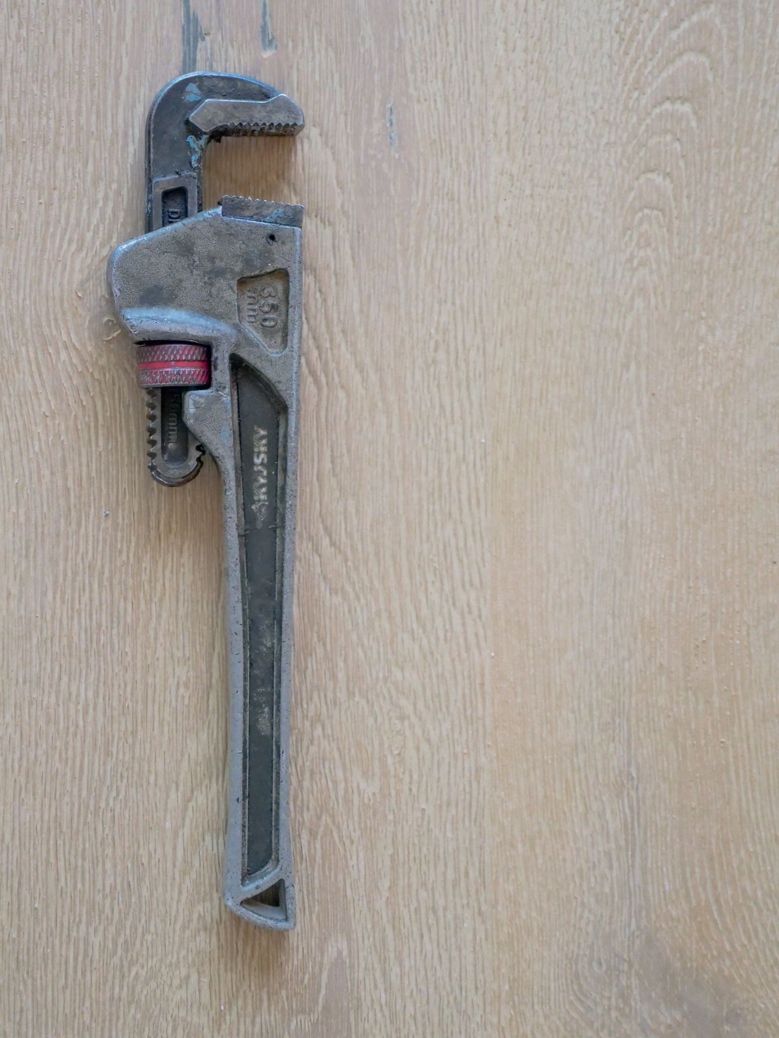 Plumber's wrench on a workbench — the Boone Plumbing trade